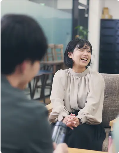 リラックスした雰囲気のオフィスで笑顔の女性社員